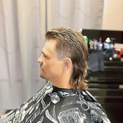Side view of a modern mullet with faded sides and length at the back